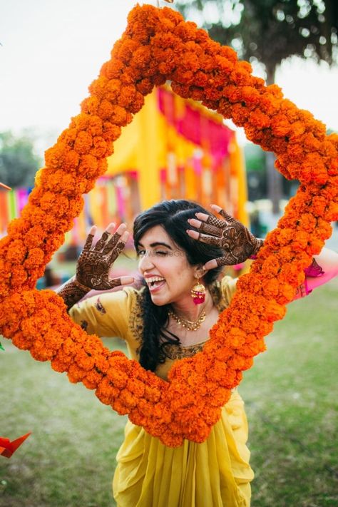 30+ Amazing Photobooths That We Spotted At Real Weddings! | WedMeGood Orange Flower Garland, Marigold Flower Garland, Color Home Decor, Mehendi Decor Ideas, Mehndi Party, Wedding Photo Booth Props, Desi Wedding Decor, Mandap Decor, Mehndi Decor