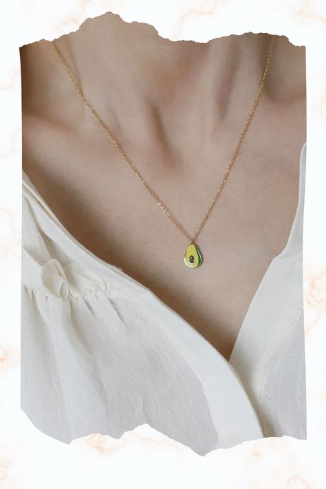 This unique and trendy gold necklace features a beautifully crafted avocado pendant that is sure to turn heads. The avocado is made of high-quality metal with a shiny gold finish, and is attached to a delicate gold chain that is adjustable to fit any neck size. This necklace is perfect for avocado lovers who want to add some fun and personality to their jewelry collection. It's also a great gift idea for friends and family members who appreciate quirky and unconventional accessories. Trendy Gold Necklace, Green Avocado, Delicate Gold Chain, Pendent Necklace, Necklace Minimalist, Necklace Gift, Gold Finish, Family Members, Gold Chain