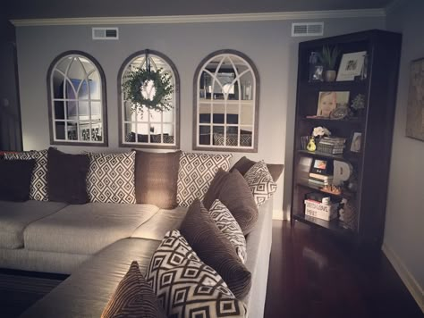 Arched mirrors and succulent wreath. Farmhouse style. I don’t like our couch, but it's huge and we have 65 kids. Arched Couch, Arched Mirrors, Above Couch, French Country Living Room, Succulent Wreath, Small Remodel, Floor Remodel, Wreath Farmhouse, Country Living Room