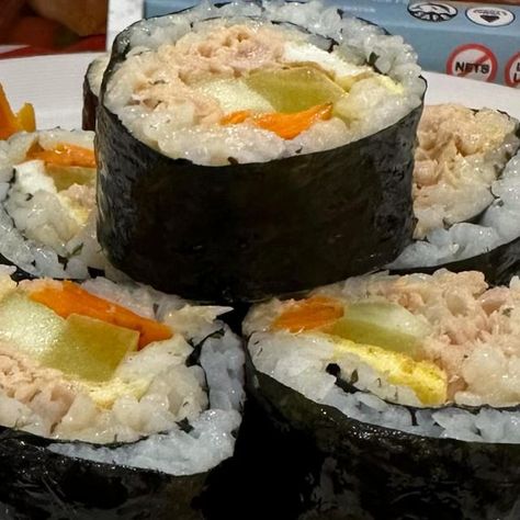 Julia Vuong on Instagram: "SPICY TUNA KIMBAP 🌶️🐟🍙 I can eat this seven days a week 😉 Easy peasy snack any time of the day. Fold, tuck, roll n squeeze is also stuck in my head. I used @naturalcatchtuna spicy chili yellowfin tuna. Just because we use canned tuna, doesn’t mean we should throw quality out the window. This was the best canned tuna I’ve ever had - so flavorful and clean! Use my code “SPICYJUJU” for 20% off your entire order (link is also in my bio). Ingredients (1-2 servings): -1 Natural Catch Tuna can -1 cup of cooked rice -2 tbsp mayo -pickled daikon -carrots -cucumber -sesame seeds -2 eggs -2 sheets of seaweed -green onion ENJOY! #naturalcatchtuna #tuna #kimbap #cookingreel #bts #jungkook #easyrecipe #koreanfood #ad" Tuna Kimbap, Pickled Daikon, Tuna Can, Yellowfin Tuna, Canned Tuna, Cooked Rice, Spicy Tuna, Spicy Chili, Stuck In My Head