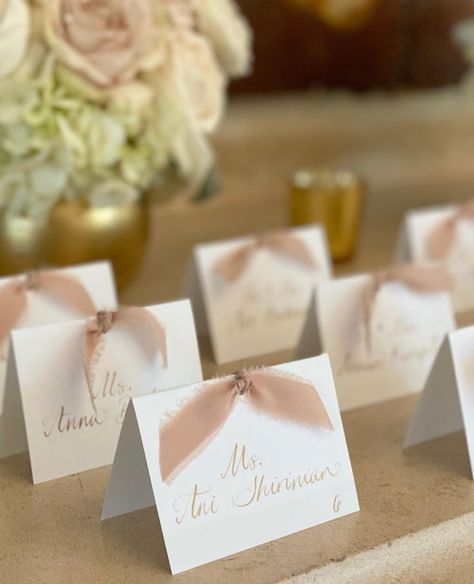 Tented place cards with calligraphy and gold ink. Tent Place Cards Wedding, Champagne Place Cards Wedding, Place Card With Ribbon, Wedding Placecard Table Sign, Name Cards With Ribbon, Bridal Shower Place Cards Ideas, Wedding Name Cards Diy, Seating Cards Ideas, Meal Indicator Place Cards