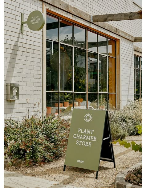 The Dreamy New Retail Space Of A Professional Plant Charmer Retail Ideas Creative, Plant Signage Design, Cheesecake Packaging, Plant Store Branding, Plants In Retail Store, Plant Store Aesthetic, Signage Flowers, Bloom Bar Signage, Outdoor Shopping Center