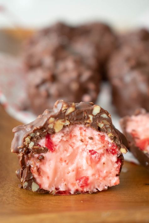 inside of cherry mash candy. Pink candy center with cherry pieces can be seen Cherry Nougat Candy, Sees Candy Rum Nougat Recipe, Joanna Gaines Cherry Mashers, Candy Balls Recipe, Xmas Deserts Easy, Grandmas Christmas Candy, Cherry Mash Truffles, Cool Whip Candy Recipe, Simple Christmas Candy Recipes