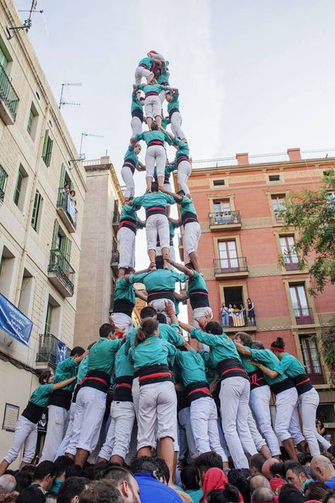 The human pyramid  Each year in August, the streets of Barcelona in Spain turn into a week-long festival with various events, including the iconic “human pyramid” tradition.  In these photos, local artists can be seen creating human towers in Vila de Gracia, the city’s historic old center, in an annual festival called Festa de Gracia.  Known as “castells,” the awe-inspiring stunt is an ancient Catalonian tradition dating back to the 18th century. Human Pyramid, Local Artists, Great Photos, The Streets, Pyramid, Barcelona, Spain, Tower, Turn Ons