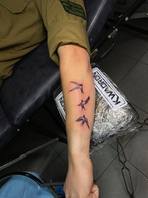 A Tattoo of 3 swallows on a soldiers arm Birds Around Arm Tattoo, Bird On Forearm Tattoo, 3 Birds Tattoo Men, Men Bird Tattoo Arm, 3 Swallow Bird Tattoo, Small Bird Tattoo Men Arm, Mens Sparrow Tattoo, Sparrow Tattoo Forearm, Men Swallow Tattoo