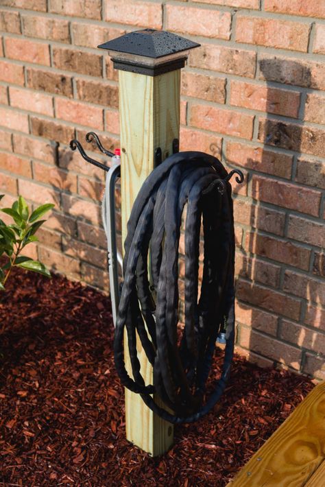 My finished garden hose organization and storage post with solar light looks great. Hose Post, Garden Hose Storage, Garden Hose Holder, Yard Diy, Hose Storage, Garden Watering, Hose Holder, Garden Hoses, Outdoor Diy Projects