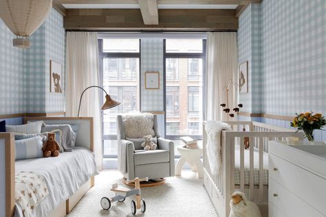 Glider rocker in front of large windows between daybed and crib in nursery with blue and white gingham walls. Crib And Daybed In One Room, Nyc Nursery, Nursery Daybed, Preppy Baby, Dreamy Nursery, Changing Table Dresser, Glider Rocker, Unisex Nursery, Playful Decor