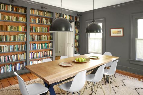 Dining rooms make ideal libraries because they often have expansive walls that can be transformed into bookshelves,” Johns says. She chose the largest wall—where a hutch or server might go—for the beadboard-backed shelves and built them floor to ceiling so they became part of the architecture. The wall of windows opposite offers light and views. Library Room Design, Dining Room Library, Floating Shelves Kitchen, Farmhouse Renovation, Dining Room Remodel, Room Library, Dining Room Ideas, Dining Room Combo, Estantes Flotantes