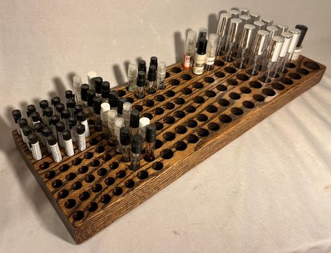 "This beautiful, handcrafted display organizes and stylishly showcases all of your perfume and cologne samples and decants in one fashionable place. This display was made from solid Oak, with a dark stain to enhance the beauty of the natural grain patterns, and finished with a light gloss. Capacity- <1ml samples- 50 ~1ml samples- 20 ~3ml samples- 35 5ml- 24 10ml- 30 Oversized 5ml- 4 Approximately measures 18\" x 6\" Customizations are available, just message me directly!" Fragrance Sample Storage, Small Perfume Shop Interior Design, Perfume Display Ideas, Cologne Display, Perfume Collection Display, Fragrance Display, Perfume Stand, Fragrance Storage, Perfume Storage