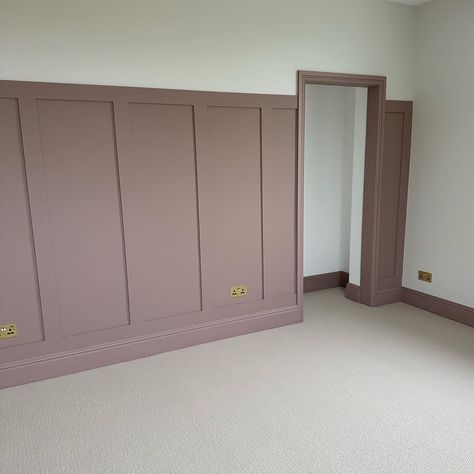 A neutral, textured carpet, paired with panelling and skirting boards painted in a muted, dusky pink tone. The image features traditional style radiators painted in a glossy white shade. Bedroom Inspirations Feature Wall, Panelling Dormer Bedroom, Pink Panel Wall Bedroom, Dusty Pink Dressing Room, Pink Panelling And Wallpaper, Master Bedrooms Decor High Ceiling, Bedroom Panneling Ideas Pink, Sulking Room Pink Girls Bedroom, Dusky Pink Walls