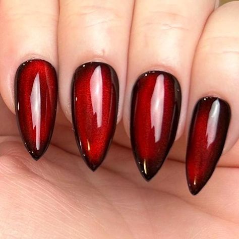 Pictured in medium stiletto and medium square.  Black Apres Gel X press-on nails with silver reflective cat eye topped with blood red jelly color gel. Looks completely black until the light hits just right, revealing a striking blood-red hue, almost appearing as if it's lit from within. Please note: colors and shine will vary depending on photography, lighting and angles. --MATERIALS AND CRAFTSMANSHIP-- This set is crafted with meticulous care using high-quality UV gel materials, including Après Black Cherry Cat Eye Nails, Red Reflective Nails, Blood Red Cat Eye Nails, Red Black Chrome Nails, Red Jelly Cat Eye Nails, Red And Black Chrome Nails, Red And Black Cat Eye Nails, Red Moon Nails, Moulin Rouge Nails