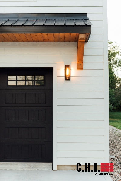 black garage doors on farmhouse exterior Haas Garage Doors 600 Series, Overhang Roof Ideas, Garage Eyebrow, Garage Overhang, Eyebrow Roof, Modern Farmhouse Garage, Garage Facade, Exterior Paneling, Black Garage Doors