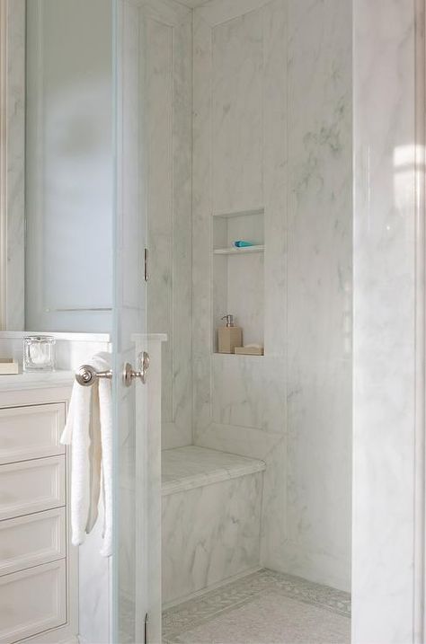 Gorgeous wing out, frosted glass door opens to a walk in shower fitted with a white marble slab shower surround accented by a matching shower bench and shower niche as the shower floor is covered in ming green border tiles surrounding white marble mosaic shower floors tiles. Bathroom Shower Doors Ideas, Shower Doors Ideas, Bathroom Shower Doors, Doors Ideas, Frosted Glass Door, Marble Showers, Shower Floor Tile, Bad Inspiration, Shower Cabin