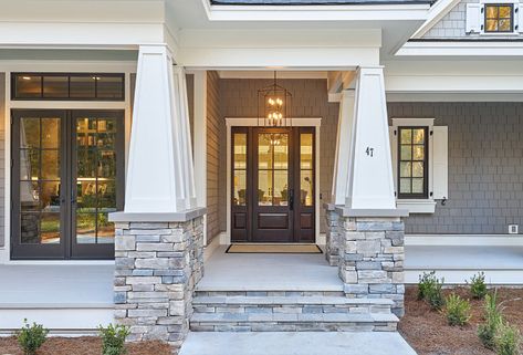 Cape Cod home front porch Wide front porch with the stacked stone pillars and the beautiful front door with sidelights Home exterior Home Porch Front Porch Cape Cod home front porch Wide front porch with the stacked stone pillar #CapeCod #CapeCodhome #frontporch #porch #Widefrontporch #stackedstonepillars Lake House Interior Design, Front Porch Stone, Cape Cod House Exterior, Cape Cod Cottage, Sliding French Doors, Lake House Interior, Transitional Exterior, Exterior Home Design, James Hardie