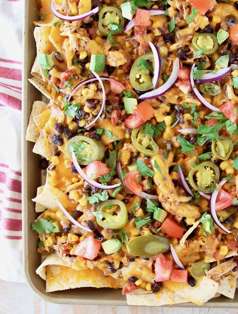 The best Chicken Nachos are loaded up with shredded chicken, tomatoes, chilies, beans & spices all cooked together in an easy crockpot recipe! #crockpot #easy #chicken #nachos #recipe Pasta Recipes Cheesy, Pulled Chicken Nachos, Walnut Chicken Recipe, Cheesy Appetizers, Salsa Chicken Crockpot, Cheesy Pasta Recipes, Smoked Chicken Breast, Chicken Tomatoes, Recipe Crockpot