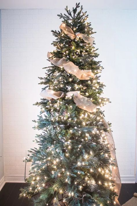 How to Put Ribbon Garland on a Christmas Tree | Hunker Garland On A Christmas Tree, Christmas Tree Ribbon Decorating, Ribbon On Christmas Tree Ideas, Christmas Tree Topper Ribbon, Christmas Tree Ribbon Garland, Black Christmas Tree Decorations, Christmas Tree Ribbon, Christmas Tree Village, Burlap Christmas Tree