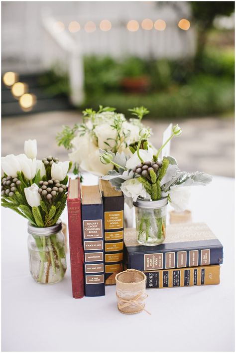 Emily + Jon Book Party Centerpieces, Book Themed Wedding Centerpieces, Vintage Grad Party, Book Themed Graduation Party, Centerpieces With Books, Masters Graduation Party Ideas, Vintage Book Centerpiece, Vintage Graduation Party, Graduation Display