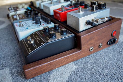 Custom walnut pedal board for guitar effects pedals. It is inspired by wooden end caps on vintage synthesizers and has an underside mounted power supply and wired input/ouput jacks on one side panel. Wood Pedalboard, Vintage Synthesizers, Pedalboard Design, Pedalboard Ideas, Diy Pedalboard, Guitar Pedal Board, Guitar Pedal Boards, Diy Guitar Pedal, Dovetail Box