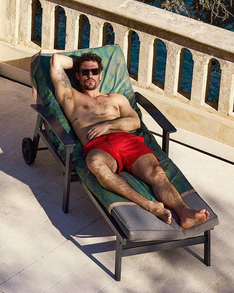 Man on sun lounger wearing primary red swim shorts. This image was included in the article: 8 Major Men’s Swimwear Trends For Summer 2023, on MensFlair.com Trends For Summer 2023, Summer Co Ords, Tonal Prints, Poolside Fashion, Saturdays Nyc, Men's Swimwear, Swimwear Trends, Mens Loungewear, Men Beach