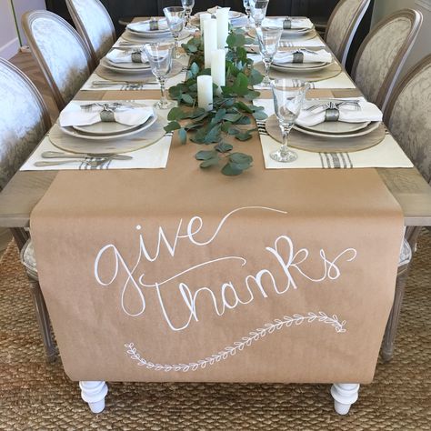 Thanksgiving easy table setting. Kraft paper runner.  Magnolia home placemats. Fresh eucalyptus and candles Low Budget Thanksgiving Table Decor, Butcher Paper Food Display, Thanksgiving Craft Paper Table Runner, Thanksgiving Set Up For Large Family, Mexican Thanksgiving Decor, Silver Thanksgiving Table Decor, Diy Friendsgiving Decor, Simple Dinner Party Table Decor, Friendsgiving Table Setting Disposable