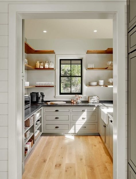 Large walk-in cabinetry featuring white counters with black countertops. The walnut finished shelves match with the hardwood flooring. Corner Kitchen Pantry, Kitchen Pantry Ideas, Free Standing Kitchen Pantry, Small Kitchen Pantry, Farm Style Kitchen, Kitchen Pantry Cupboard, Pantry Room, Built In Pantry, Large Pantry