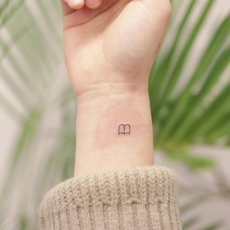 Book Tok Tattoo, Tiny Book Tatoos, Bookish Minimalist Tattoo, Minimalist Reader Tattoo, Book Stick And Poke Tattoo, Book Tattoo Small Simple, Book Micro Tattoo, Small Book Related Tattoos, Tiny Book Tattoo Simple