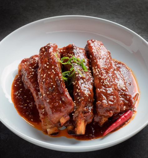 Korean braised pork ribs in a white bowl. Korean Braised Pork, Spare Ribs Slow Cooker, Gochujang Glaze, Ribs Slow Cooker, Korean Ribs, Braised Pork Ribs, Korean Recipe, Korean Pork, Bbq Pork Ribs