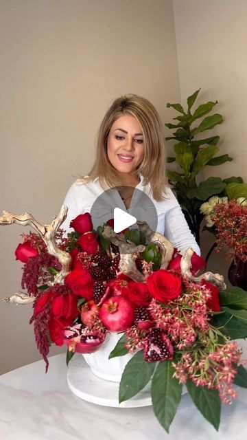 Parisa Karloo | Wedding Flower & Design on Instagram: "“A touch of elegance, a splash of nature. This stunning arrangement combines the beauty of mixing fruits and flowers, featuring vibrant red roses, luscious pomegranates, and intricately textured driftwood. 🌹🍎🌿 . . . #valentinegift #valentinesflowers #flowerarrangement #hotelflowers #pomegranate" Pomegranate Flower Arrangement, Fruit And Flower Arrangements, Pomegranate Centerpiece, Pomegranate Wedding, Red Rose Arrangements, Hotel Flowers, Pomegranate Design, Wedding Flower Design, Fruits And Flowers