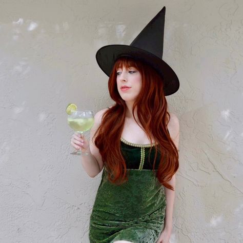 A woman wearing a green velvet dress with a layered red wig and black witch hat holds a margarita to represent the character Gillian Owens from the movie Practical Magic Practical Magic Halloween Costume, Magic Halloween Costume, Practical Magic Halloween, Gillian Owens, Halloween Dress Up Ideas, Fall Harvest Party, Harvest Party, Monster Mash, Practical Magic