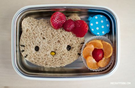 Ok I admit it -- I got a Hello Kitty sandwich cutter and I absolutely HAD to use it. It helps that my kiddos are deep in the love of all things Hello Kitty so this one is a no-brainer. Sandwich PB&J on whole wheat. Strawberry flower bow (I cut a large strawberry in half… Hello Kitty Sandwich, Hello Kitty Food, Kotak Bento, Fun Kid Lunch, Kids Lunch Box Meals, Bento Box Lunch For Kids, Cute Bento, Healthy School Lunches, Fun Lunch