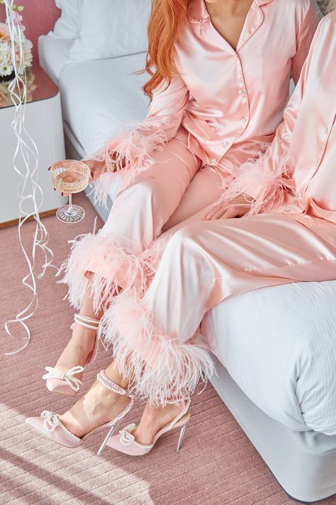 Indulge in the epitome of bedtime luxury with our Blush Fantasy Feather Pyjama Set – the perfect blend of comfort and glamour. Crafted from buttery satin, this set features exquisite ostrich feather details on the cuffs, with detachable feathers the top and bottoms for easy care. Elevate the glamour with pearl and diamond buttons, adding an extra layer of sophistication and charm. Designed for the bridal party or as an exquisite gift for a special occasion, this set boasts a timeless collar, int Bachelorette Pajama Party, Feather Pajamas, Hen Do Outfits, Pyjamas Party, Satin Dressing Gown, Bridal Pajamas, Pyjama Party, Christmas Outfit Ideas, Luxury Pajamas