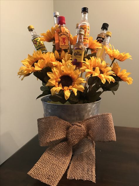 21st birthday bouquet #21stbirthday #birthday #alcohol #sunflower #burlapbow Flowers And Alcohol Gift, Sunflower 21st Birthday Party, Fall 21st Birthday Ideas, Sunflower Gift Ideas Birthday, Flower Bouquet With Alcohol, 21st Birthday Centerpiece Ideas, Alcohol Centerpieces, 21st Birthday Bouquet, 21st Birthday Table Decorations