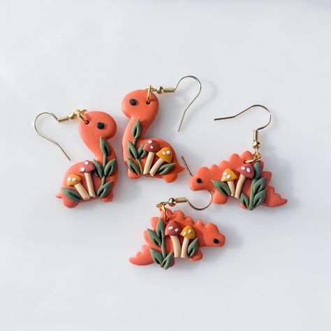 swipe to see all the dinos for this weekend!➡️ dinosaur earrings in 10 designs, dropping this saturday (march 9th) at 1PM pacific ! each of them will be available with both brontosaurus and stegosaurus options🥹🥰 i am SO EXCITED tysm to everyone who suggested i make stegosauruses because they are very adorable i think ??😫😫😫 Polymer Clay Dinosaur Earrings, Polymer Clay Dinosaur, Clay Dinosaur, Mushroom Accessories, Homemade Clay, Dinosaur Earrings, Clay Pendants, Clay Stuff, March 9th