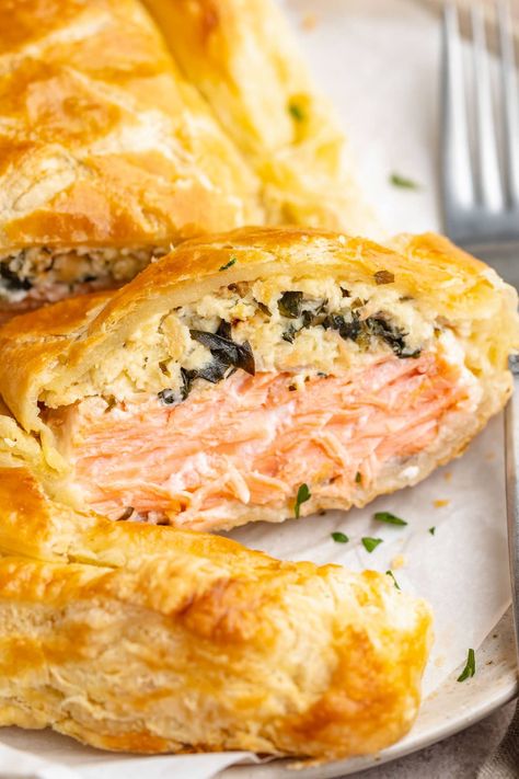 Elegant and genuinely impressive Salmon Wellington is actually incredibly easy to make. A rich mixture of cream cheese, spinah, garlic, and breadcrumbs is stuffed inside tender salmon fillets, then encased in a buttery puff pastry. Perfect for any special occasion or anytime you're feeling fancy, this restaurant-quality dish is guaranteed to please everyone at your dinner table. Salmon Wellington Recipe, Salmon Puffs, Salmon Wellington, Wellington Recipe, Pepperidge Farm Puff Pastry, Salmon Cream Cheese, Easy Skillet Meals, Party Food Buffet, Salmon Dinner