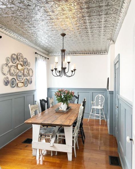 Picture Of a farmhouse dining space wiht a tin tile ceiling, grey paneling, a white dining table with a stained tabletop and a gallery wall of vintage plates Tin Ceiling Tiles Kitchen, Tin Tile Ceiling, Tin Ceiling Kitchen, Grey Paneling, Kitchen Ceiling Tile, White Tin Ceiling, Entryway Ceiling, Tile Ceiling, Being Too Much