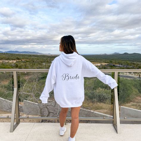 This bridal hooded sweatshirt with your custom date is a must have for your upcoming wedding! Made with a thick blend of cotton and polyester, it feels plush, soft and warm. - 50% cotton, 50% polyester - Runs true to size - Medium-heavy fabric - Both soft and stylish **Model is wearing XL for oversize look** **Bride Hoodie matches with our Bride Squad Hoodie found on our store** Make sure to rate us and enjoy! Bridal Hoodies, Wedding Hoodie, Bride Hoodie, Hoodie Customize, Bride Squad, Wedding Date, Oversize Hoodie, Cold Day, Heavy Fabric