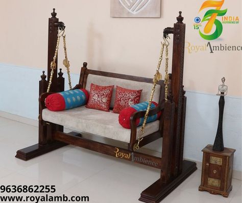 This wooden swing with delicate carving and well-thought & conceptualized design been the point of attraction since the beginning. Move it in a hallway, living room, or porch or may be outdoor with some cover to protect it from rain. Bearing for smoother swing movement strong leg support from stability. Crafted by matured craftsmen with assorted and treated timber - Sheesham wood, hand-waxed premium polish. Decorated brass chains add real charm. #woodenswing #FreeStanding #freestandswin Wooden Jhula, Swing In Living Room, Balcony Swing, Room Swing, Living Room Indian, Drawing Room Interior, Indoor Swing, Wooden Swing, Swing Design