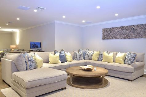 Large sectional couch with round coffee table in basement Large Sectional Couch, Finished Basement Designs, Basement Layout, Furnitur Ruang Keluarga, Modern Basement, Living Room Layout, Large Sectional, Diy Basement, Living Room Furniture Layout