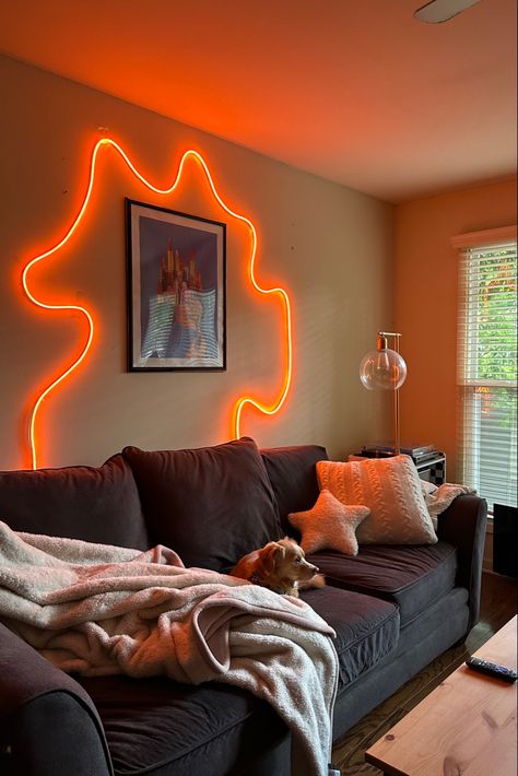 Orange LED strip artwork above grey couch Apartment Decorating Living, Living Tv, Strip Design, Light Aesthetic, Led Rope Lights, College Apartment, Apartment Decor Inspiration, Strip Lights, Lights Led