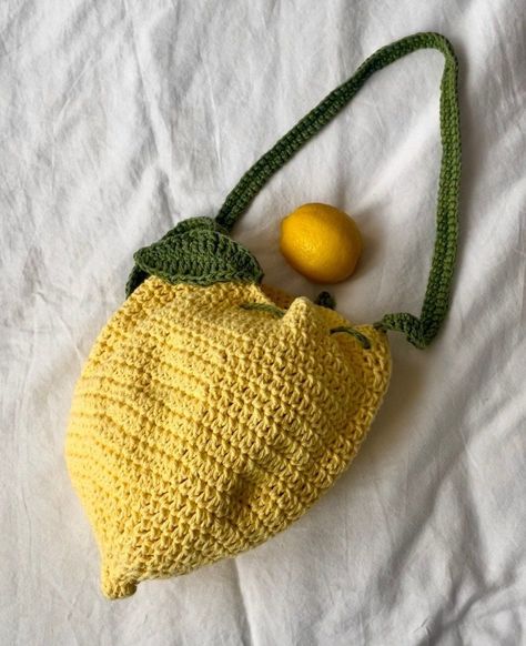 🍋HANDMADE LEMON CROCHET BAG 🍋 Part of the fruit salad collection 🍋100% cotton yarn  🍋37-inch strap 🍋10-inch bag 🍋Realistic lemon shape and leaf *Because all yarn dye is not equal, the bag may vary in color, it'll always be yellow but it ranges in vibrancy. Either way, it's cute AF ;) Lemon Crochet Top, Crochet Leaf Bag, Yellow Yarn Crochet Projects, Crochet Food Bag, Yellow Crochet Ideas, Yellow Crochet Projects, Crochet Cotton Yarn Projects, Yellow Crochet Bag, Lemon Crochet