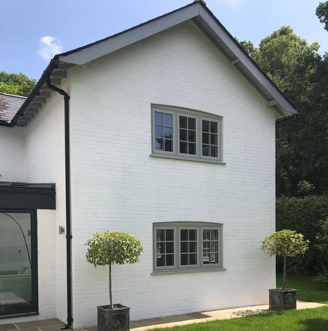 Olive Green Windows Exterior, White House With Green Windows, White Render Black Windows, Light Grey Window Frames, White Rendered House Exterior Uk, 1950s House Exterior Uk, White And Sage House Exterior, White House Green Windows, Front Colour Of House