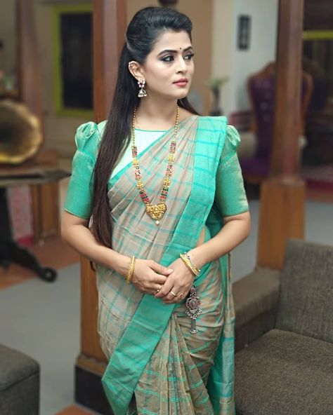 In a cyan color saree, elbow length sleeve blouse design and hip key chain Sea Green Saree, Cotton Saree Blouse Designs, Blouse Designs Catalogue, Saree Sale, Best Blouse Designs, Saree Blouse Neck Designs, New Saree Blouse Designs, Blouse Back Neck Designs, Blouse Design Images