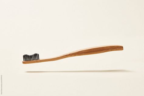 Simple wood toothbrush levitating in air for no plastic concept on beige background Wood Toothbrush, Wooden Toothbrush, Tooth Brush, Beige Background, Wood Table, Zero Waste, Brushing Teeth, Royalty Free Stock Photos, Wood