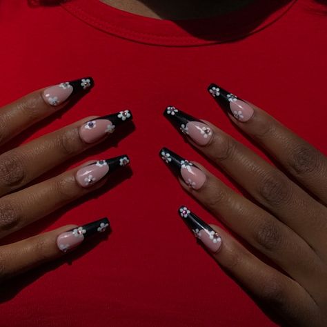 Long, black, french tip nails with a flower design. Modeled on hands with a red shirt background in the sunlight. Flower Nails Black, French Tip Summer Nails, Nails Flower, Nails Black, Press Ons, French Tip Nails, Flower Nails, Nails Nails, Black Nails