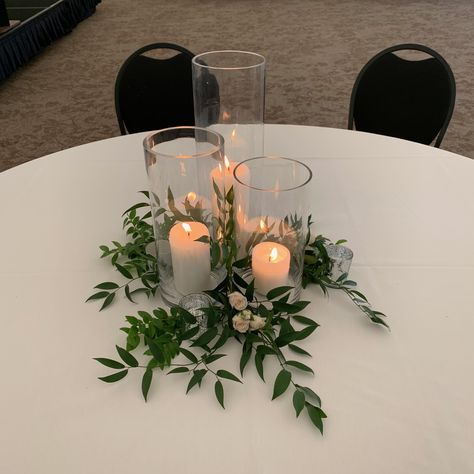 Inexpensive Greenery Centerpieces, Ivy And Candle Centerpieces, Simple Dinner Centerpieces, Candle And Eucalyptus Centerpieces Wedding, Simple Gala Centerpieces, 3 Tier Candle Holder Centerpiece, Round Table Decor For Party, Smilax Centerpiece, Greenery Circle Table Centerpieces