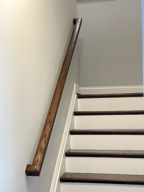 Basement railing stained using a dark stain to match the stairs. Painting Handrails For Stairs, Paint Oak Stair Railing, Stain Stair Railing, Dark Stained Stairs, Stain And Seal Wood, Basement Railing, How To Restain Wood, Wood Banister, Oak Banister