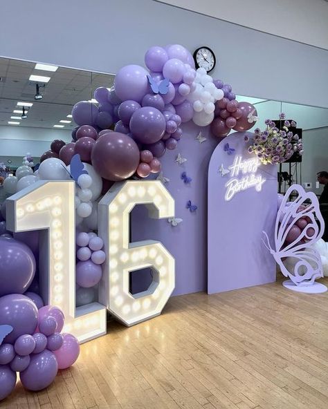 Downey Balloons on Instagram: "Butterfly 🦋 inspired Sweet 16 in the prettiest shades of purples 💜 Thank you @picogirl90660 for allowing us to create for you. ✨ It was an absolute pleasure. •This set up consisted of a fabulous custom backdrop with fresh flower arrangement, luxurious balloons, 4’ butterfly and marquee numbers.. •Grand entrance balloon arches and helium balloons throughout the venue. #sweet16party #sweet16 #sweet16backdrop #partyinspiration #partyideas #balloons #misquince # Sweet 16 Butterfly Theme Purple, Sweet 16 Purple Theme 16th Birthday, Shades Of Purple Birthday Decorations, Sweet 16 Entryway Ideas, Shade Of Purple Party, Sweet 16 Arch Ideas, Sweet 16 Party Balloons, Sweet 16 Butterfly Theme Decorations, Purple Silver Sweet 16