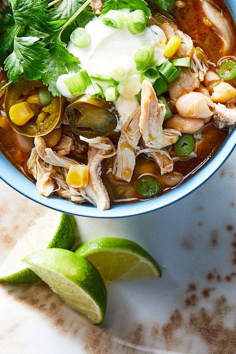 NYT Cooking: This tangy, mildly spicy white-bean chili is as warming and comforting as a traditional chili, but in a lighter, brighter form. Plenty of green chiles — fresh and canned — provide kick while creamy white beans mellow it all out. To decrease the heat level, remove and discard the seeds from the jalapeño before you mince it. A large handful of chopped cilantro added at the end brings freshness, b... Slow Cooker White Chicken Chili, White Chicken Chili Slow Cooker, White Bean Chili, Traditional Chili, White Chili Chicken Recipe, Green Chiles, Bean Chili, Best Slow Cooker, Nyt Cooking