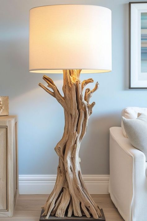 Add a rustic coastal feel to your home with a driftwood table lamp. The natural texture and light wood tone pair perfectly with soft pastels, creating a cozy, beach-inspired vibe. Wall Lamps Diy, Lamp Redo, Sculpture Lamp, Driftwood Chandelier, Funky Lighting, Diy Table Lamp, Driftwood Table, Driftwood Art Diy, Beach House Living Room