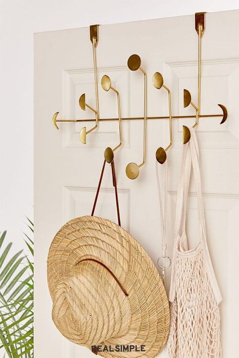 8 Genius Over-the-Door Organizers, All Under $50 | Truth: back-of-door organizers aren't exactly known for looking cute. That is, until this golden moon phase multi-hook rack was created. Slip it over the top of your closet door to hold sun hats, beach bags, and scarves. #declutter #organizationtips #realsimple #storageideas #storagetips Over The Door Organizer, Door Organizer, Tiny Space, Dorm Room Essentials, Door Hooks, Inviting Home, Boho Chic Furniture, Floral Tapestry, Room Essentials